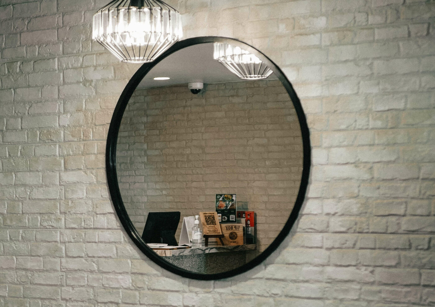 Interior whitewash brick painting finish, styled with mirror