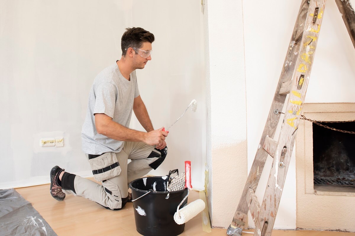 Man painting room - professional painters in perth know which type of paint to use on each project.